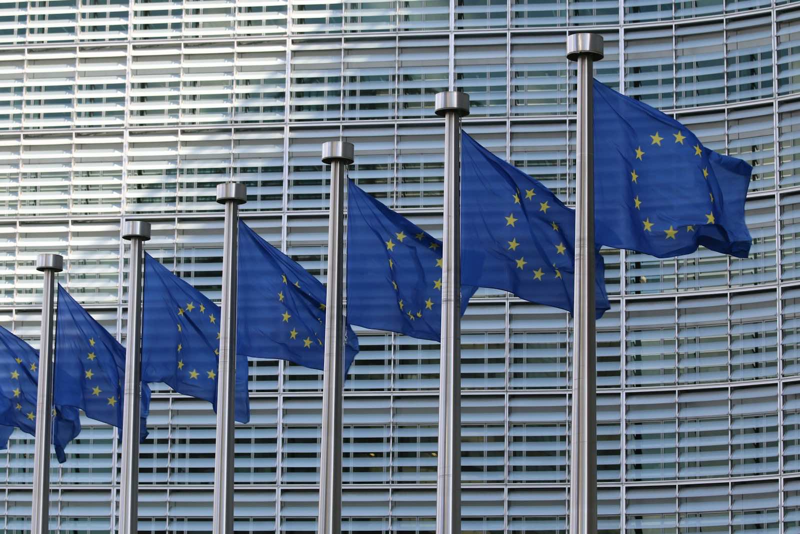 A row of European Union flags outside the European Commission building in Brussels